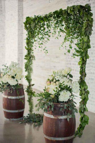 natural wedding décor greenery wedding altar with wine barrels and white flowers dave abreu photography