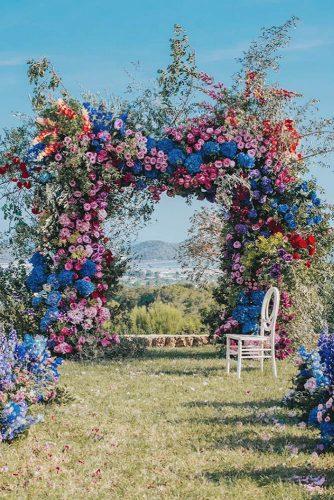 natural wedding décor outdoor ceremony arch with bright volume flowers allforlovelondon
