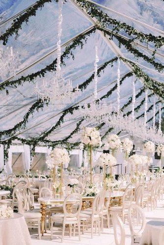 natural wedding décor transparent tent with greenery and tall white centerpieces shannons_photo