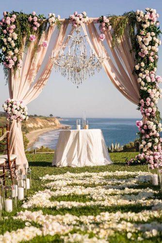 natural wedding decor outdoor ceremony arch with pink cloth and roses linandjirsa