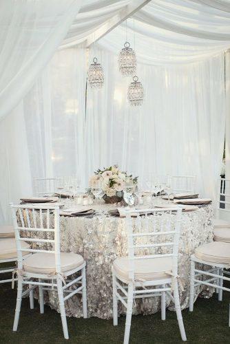 silver wedding decor ideas round table with sparkle tablecloth and flowers ashleigh taylor photography