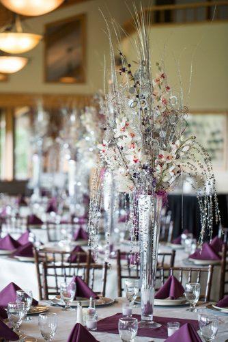 silver wedding decor ideas tall centerpiece in vase with orchids and brunches the larken photo & video co