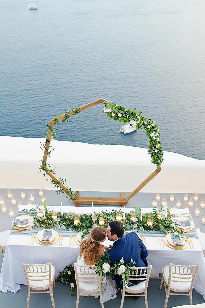 summer wedding trends outdoor reception long table with greenery thanasiskaiafas