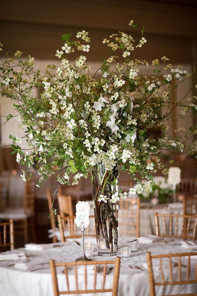 tall wedding centerpieces glam rustic greenery and white flowers in glass vase chris bailey photography