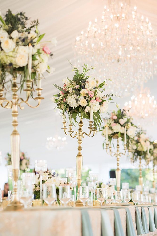 tall wedding centerpieces gold elegant with flowers and candles under white tent reception allisonlewisphotography