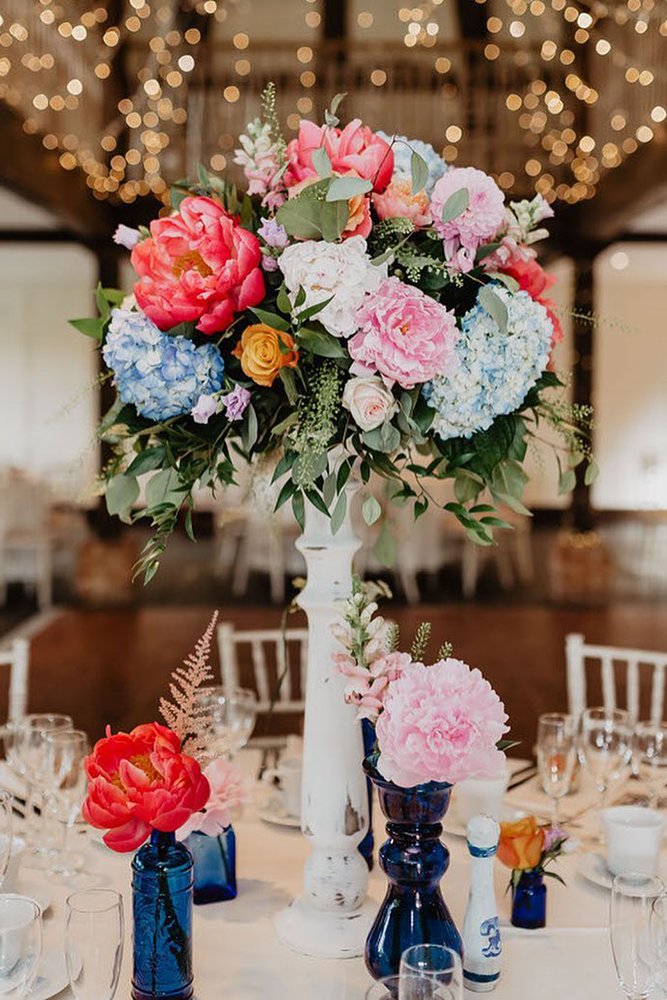 tall wedding centerpieces in wooden white vase colorful flowers kelsie low photography