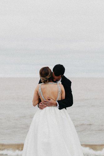 wedding photographers romantic couple together near sea