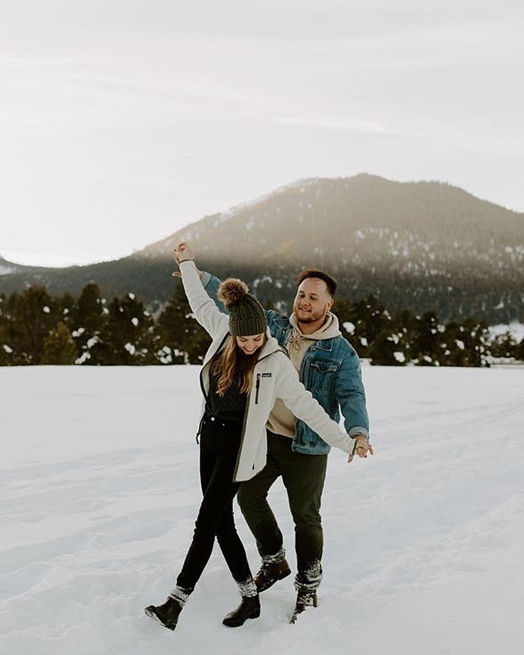 winter engagement photos happy couple in the snow