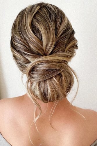 wedding updos messy low chignon with loose curls pearly.hairstylist