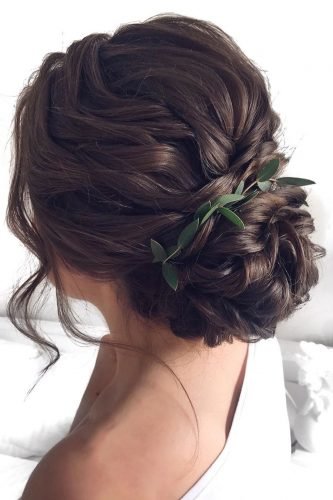 wedding updos wavy vloume low bun with greenery mpobedinskaya