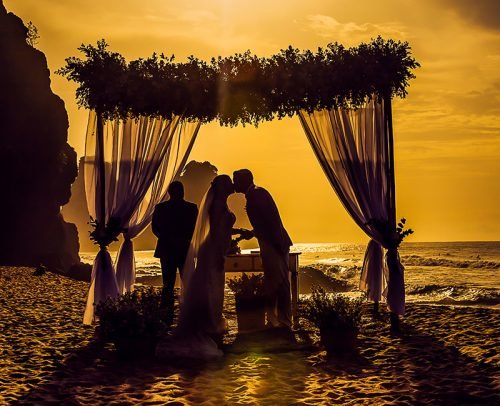 officiant prices for wedding beach newlyweds kiss
