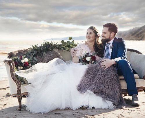 secular wedding ceremony script couple sitting on the beach
