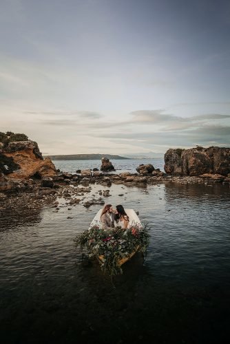 styled photo shoot island of tabarca groom bride in boat with flowers oscarguillen