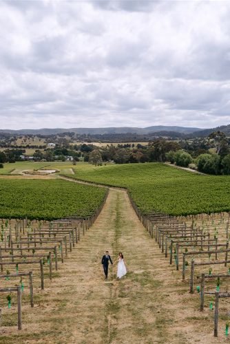 yarra valley elegant vineyard wedding drone photo with groom and bride rick liston