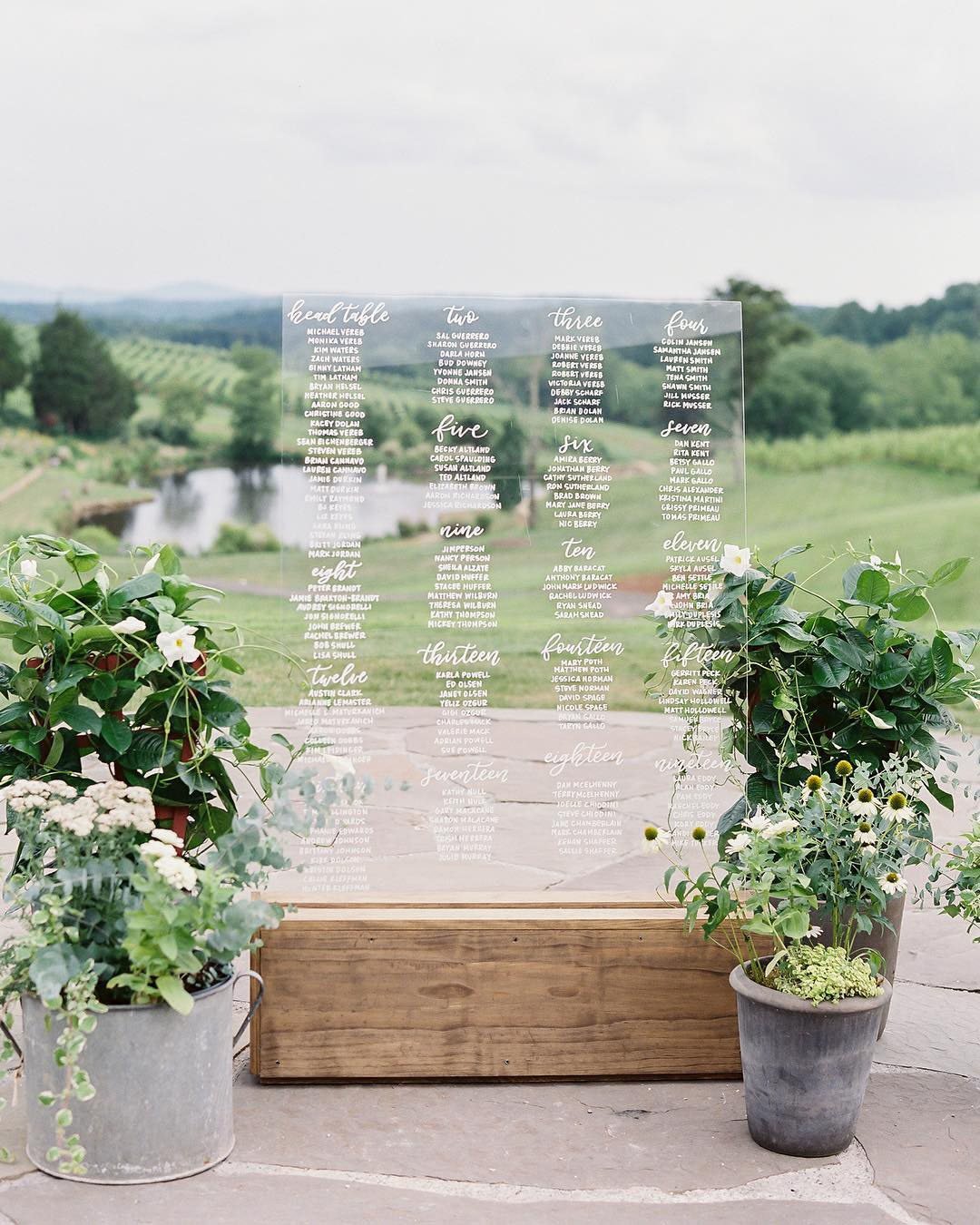 wedding trends potted flowers near seating chart