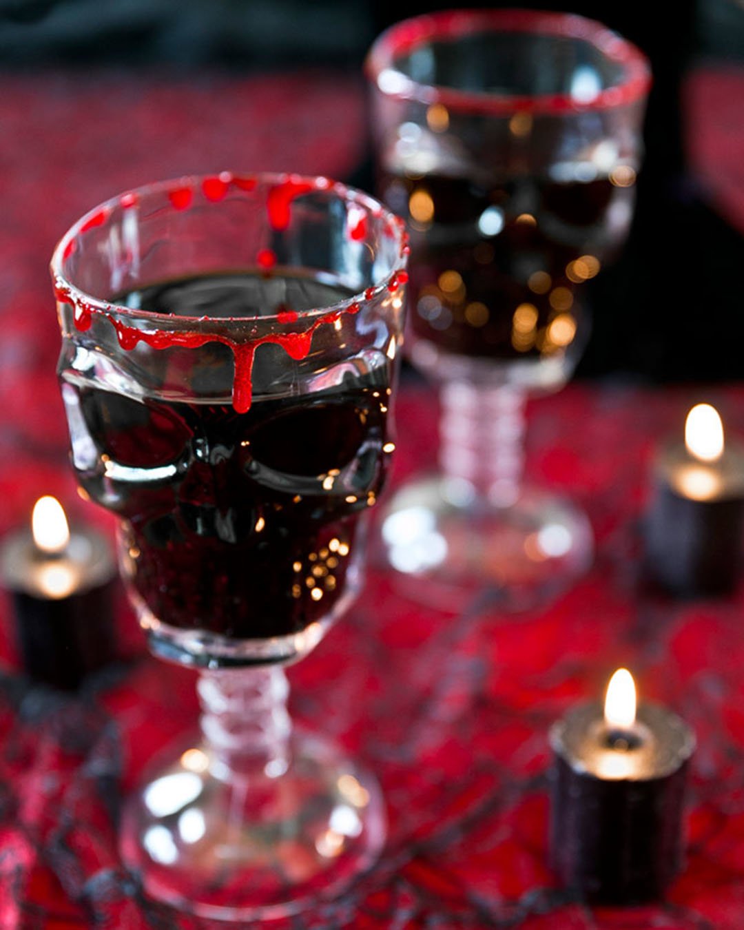 halloween bridal shower ideas red cocktail in skull glass