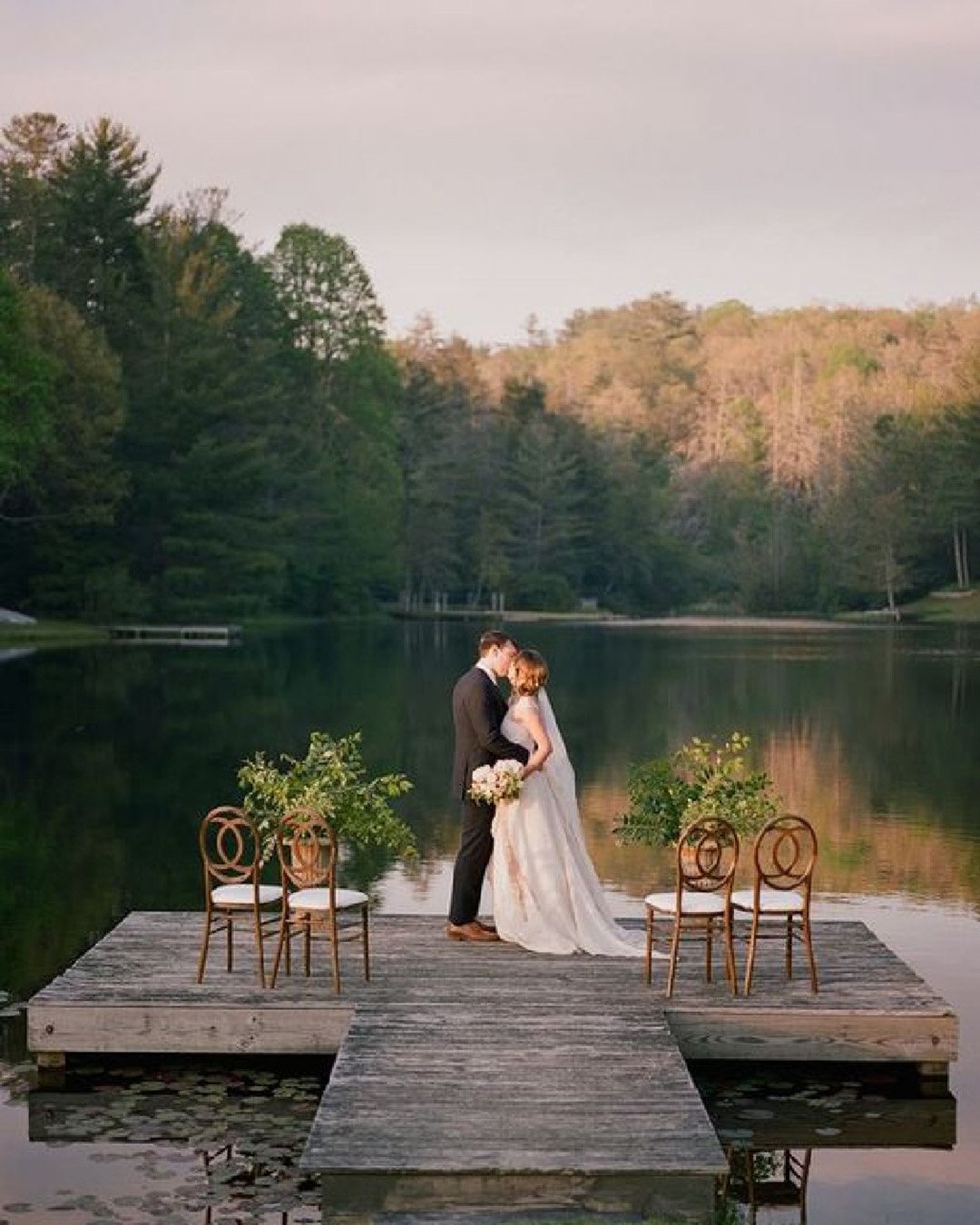 micro wedding venues groom and bride kissing on dock davy whitener