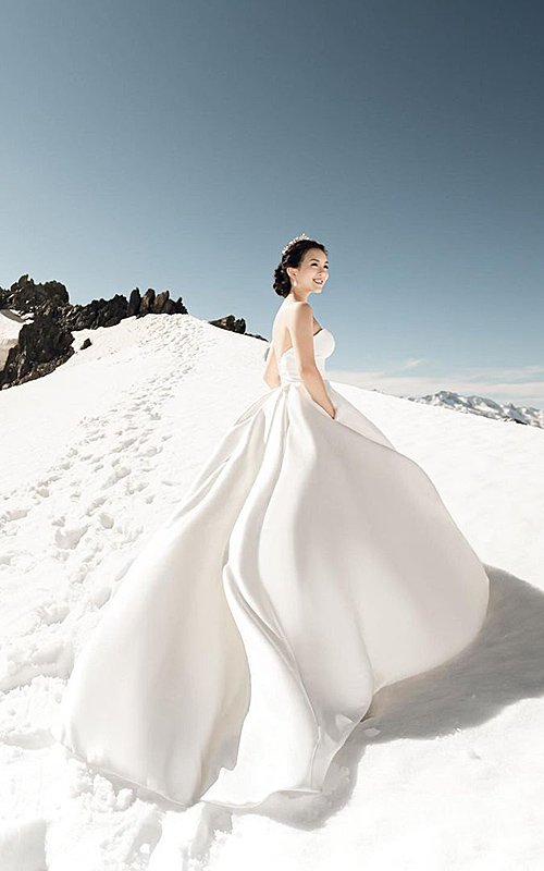 winter wedding photo ideas smiling bride in front of mountains onethreeonefour