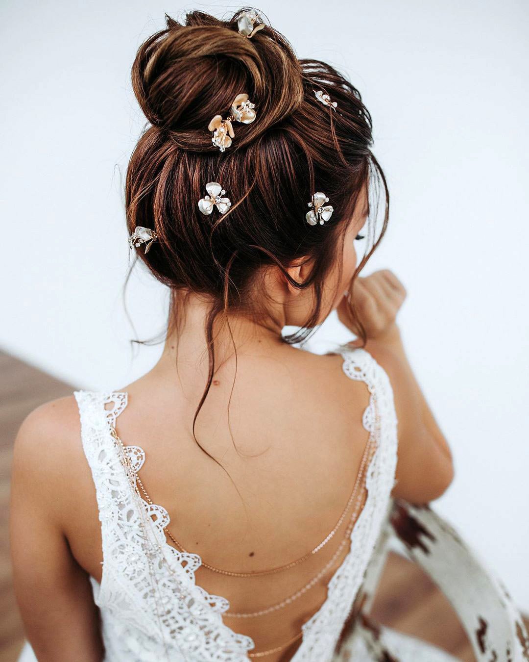 wedding updos elegant high bun with flower pins juliafratichelli.bridalstylist