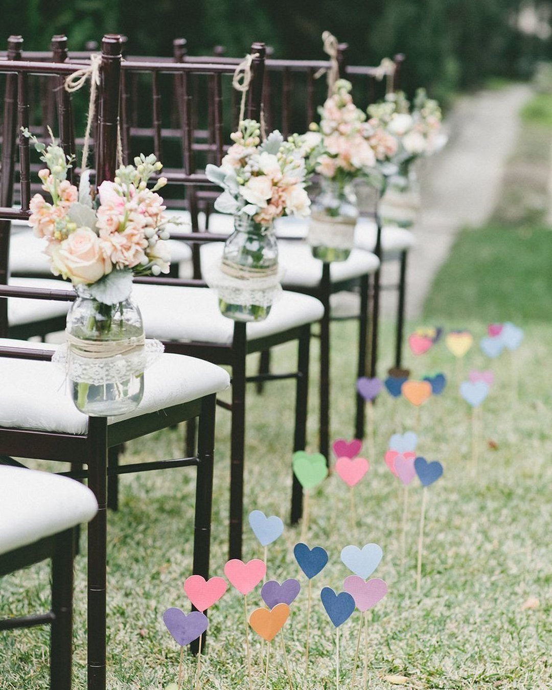 cheap wedding decorations colorful hearts made of paper at the wedding chairs decorated with mason jar with one love photo