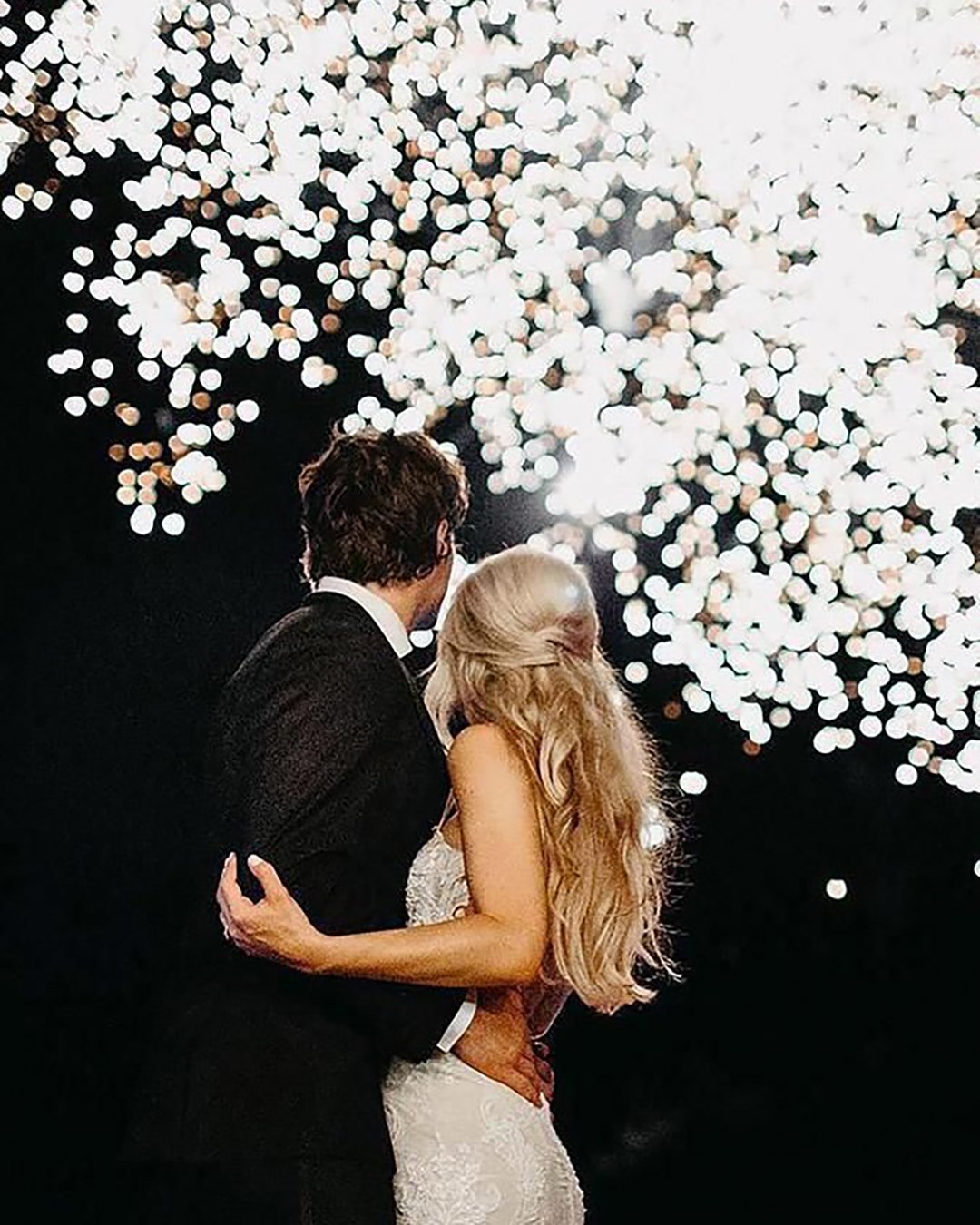 popular wedding photo ideas couple under silver fireworks janelle elise photo