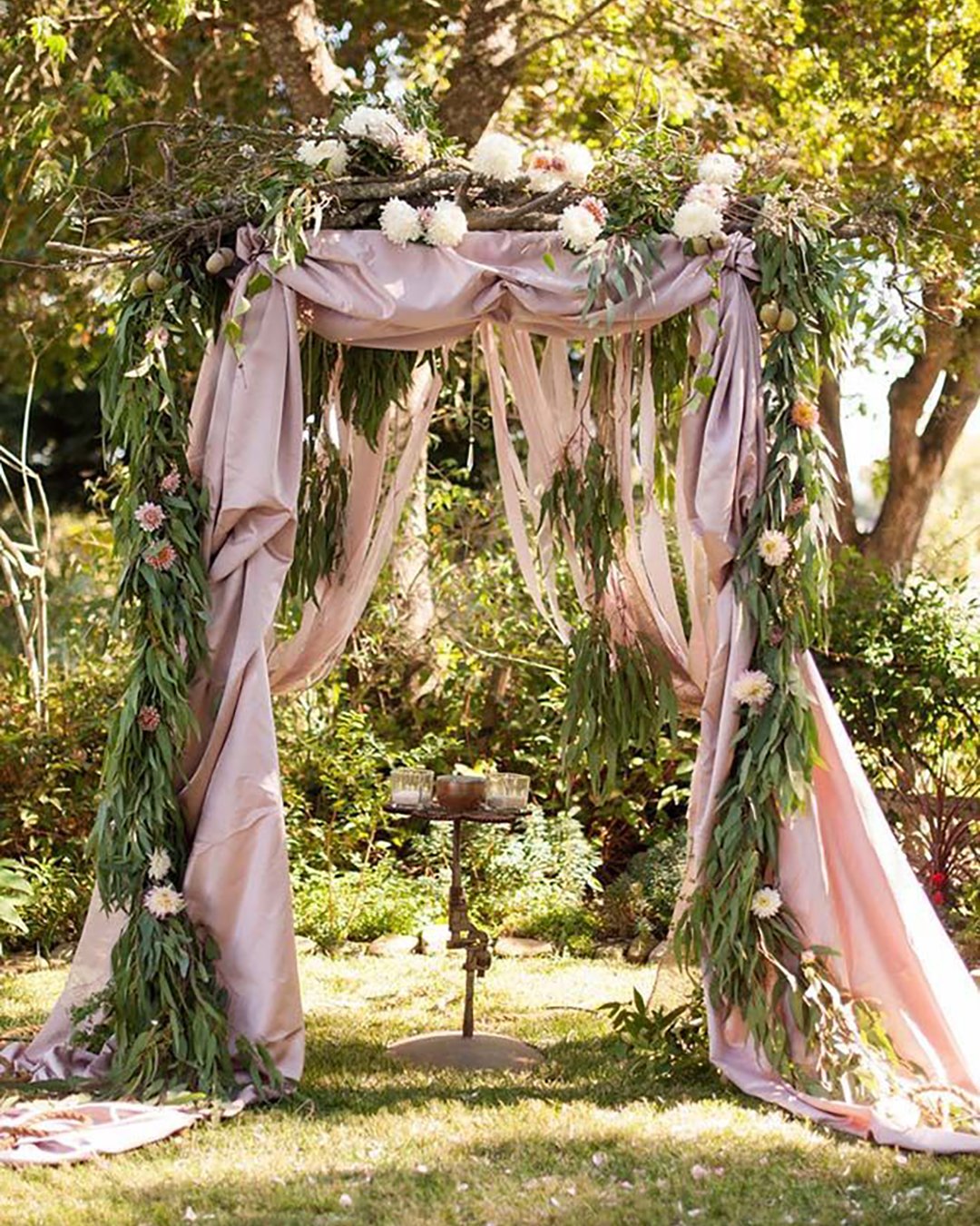 rustic wedding decor arch with blush cloth brunches and flower greenery so eventful