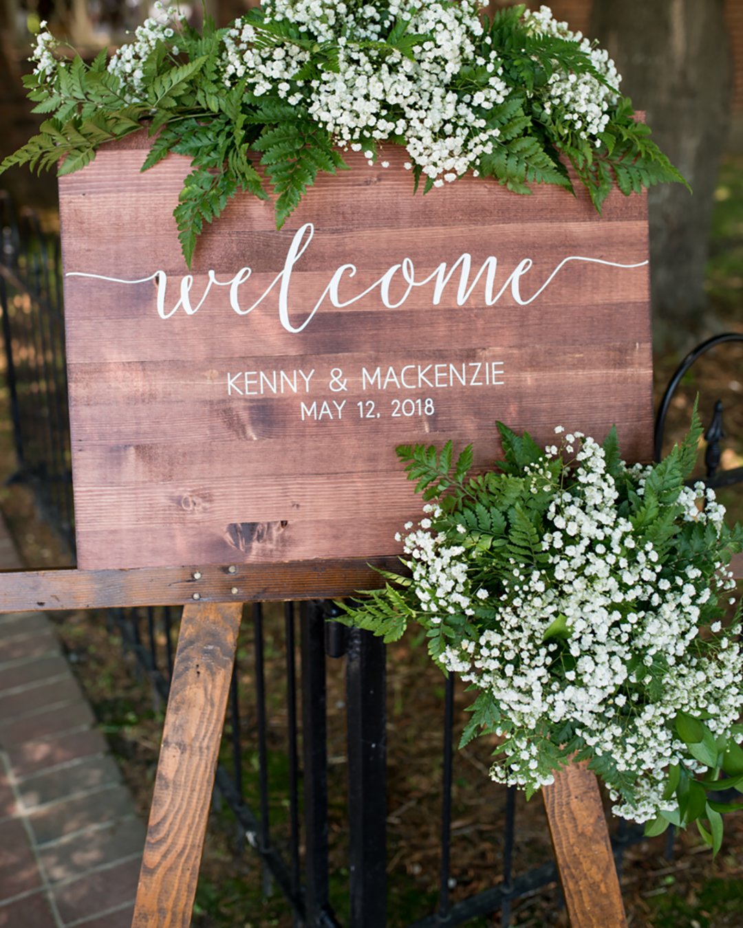 rustic wedding decor woodland welcome sign stand with greenery with baby breath maria grace photography