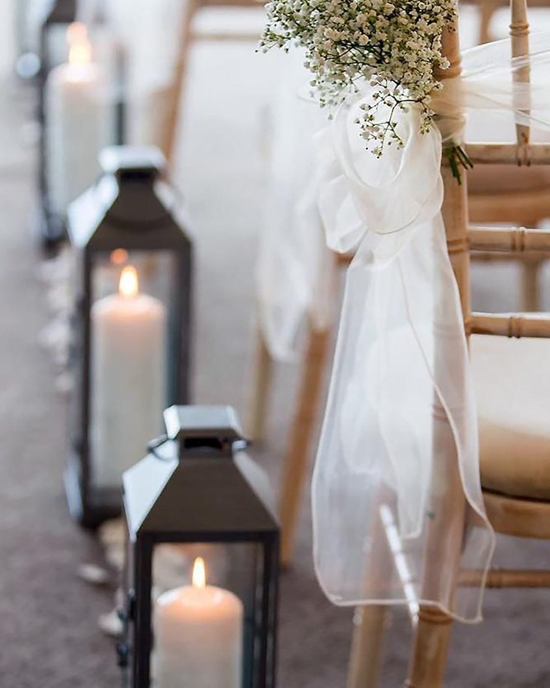 rustic wedding décor aisle decorated baby breath and white cloth with lanterns stargazey hire via instagram