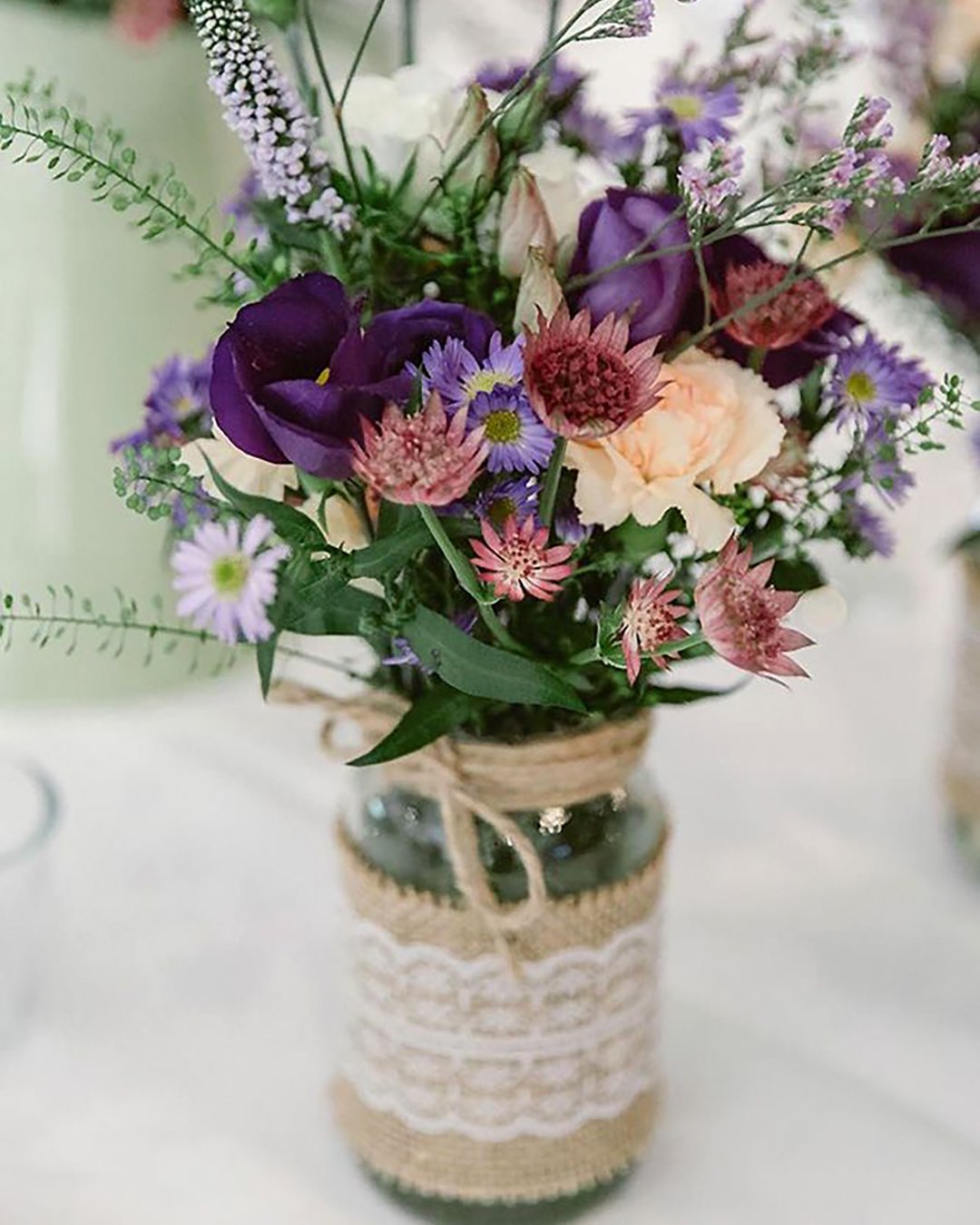 rustic wedding décor centerpiece decorated with lace wildflowers and roses decorate the table natalie j watts via instagram