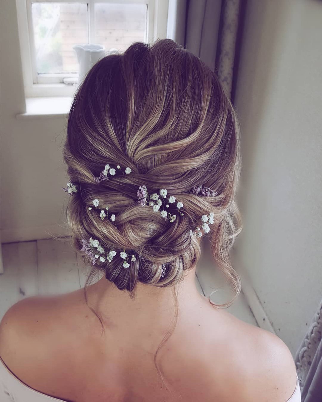wedding hairstyles for medium hair low updo with flowers hairbyhannahtaylor