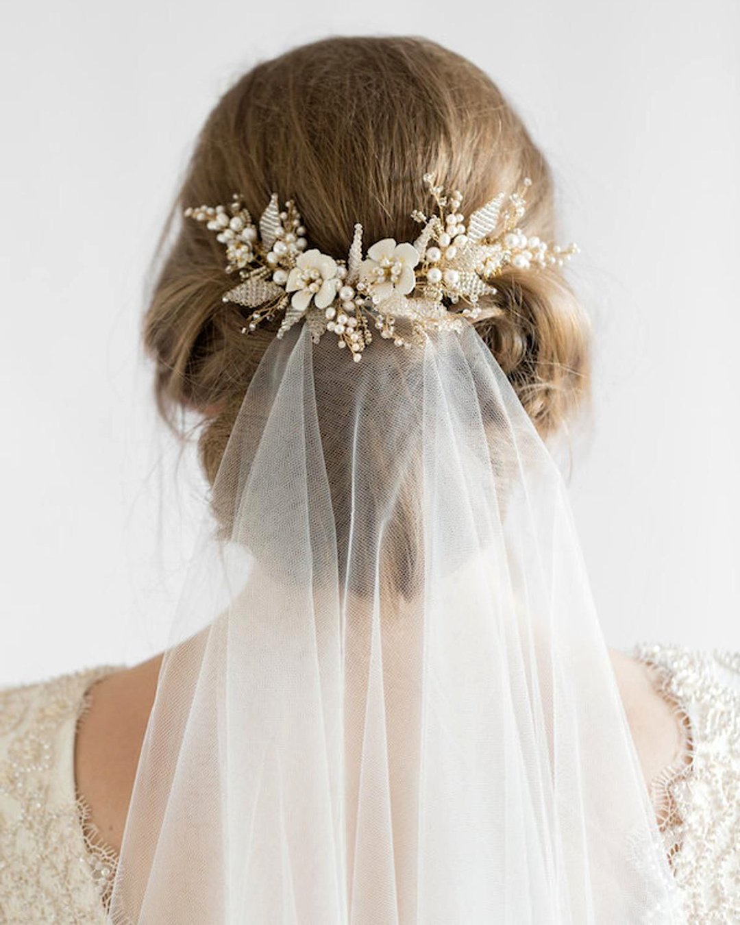 wedding hairstyles with veil low updo and pearls taniamaras