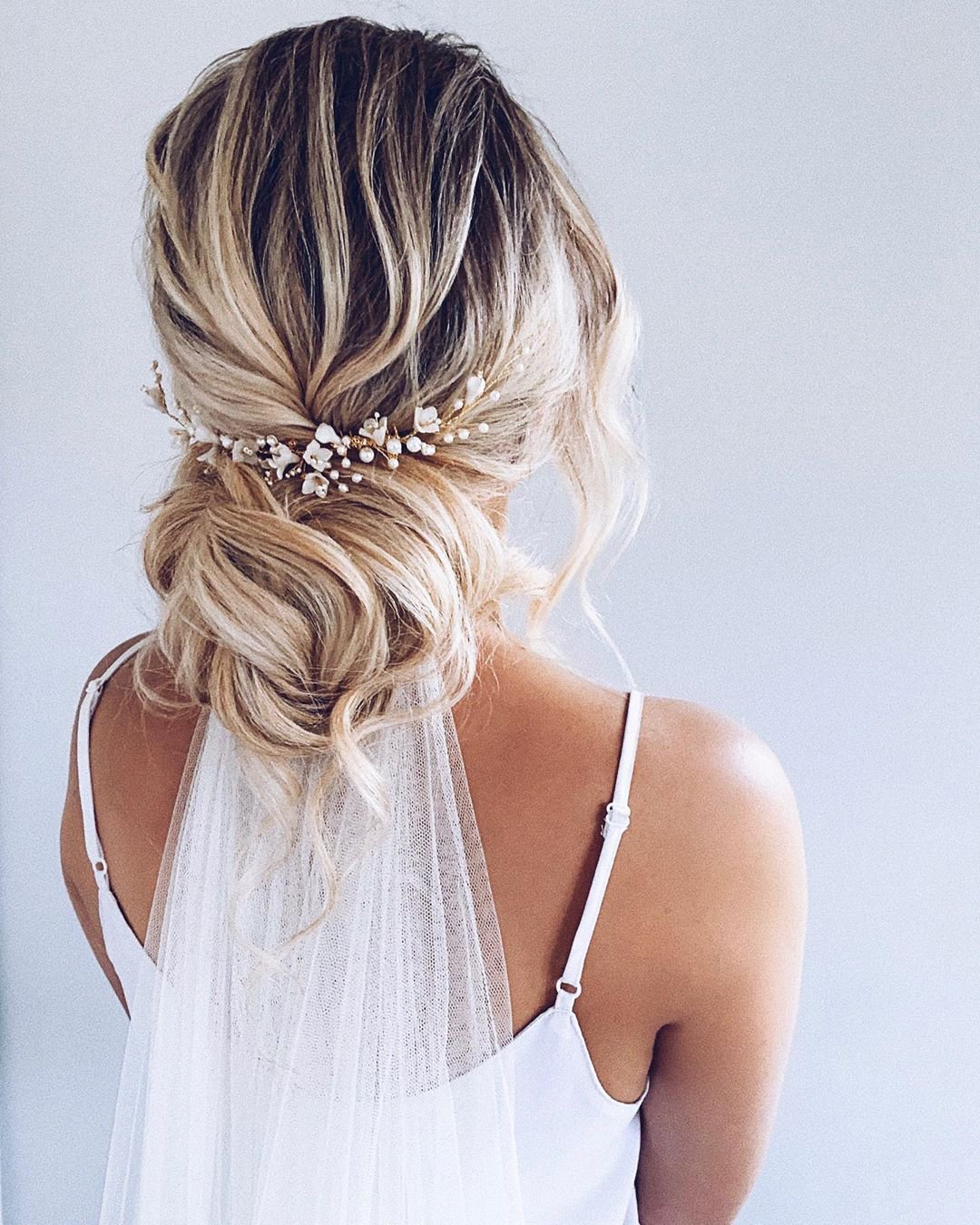 wedding hairstyles with veil volume low updo and pearls polishedstylejustine