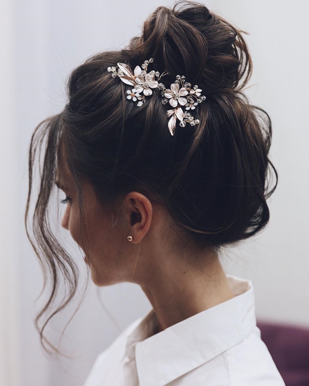 elegant wedding hairstyles high bun with flower pins tonyastylist