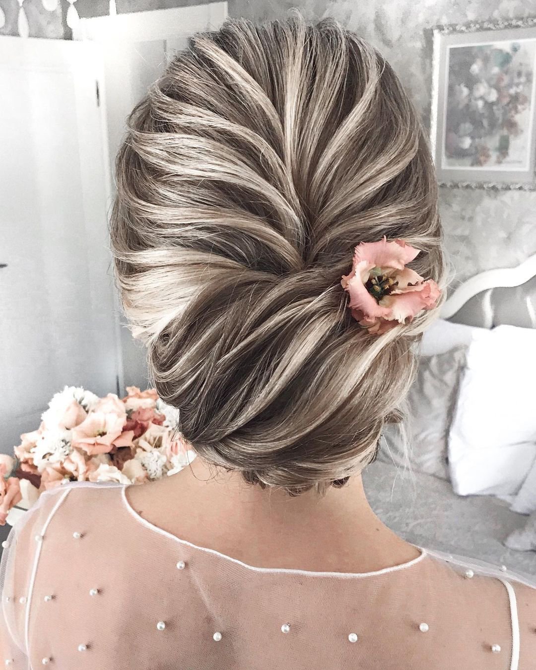 elegant wedding hairstyles textured low bun with flower mpobedinskaya