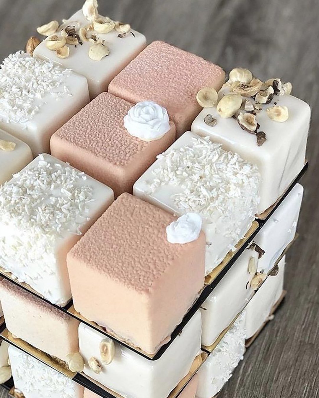 non traditional wedding dessert ideas square chite and pink cakes folded in cube decorated with nuts nivskaya