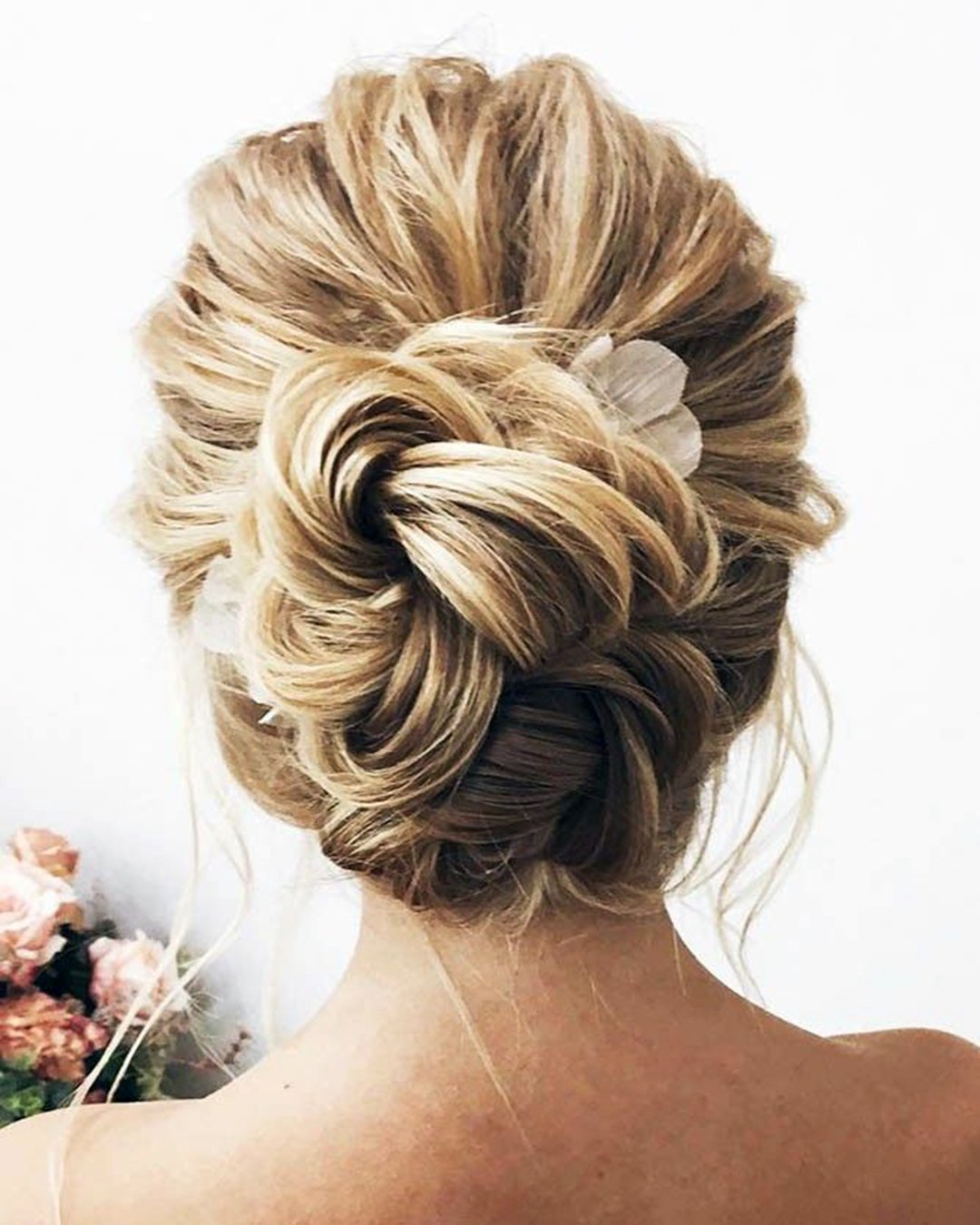 swept back wedding hairstyles bun textured with flowers lenabogucharskaya