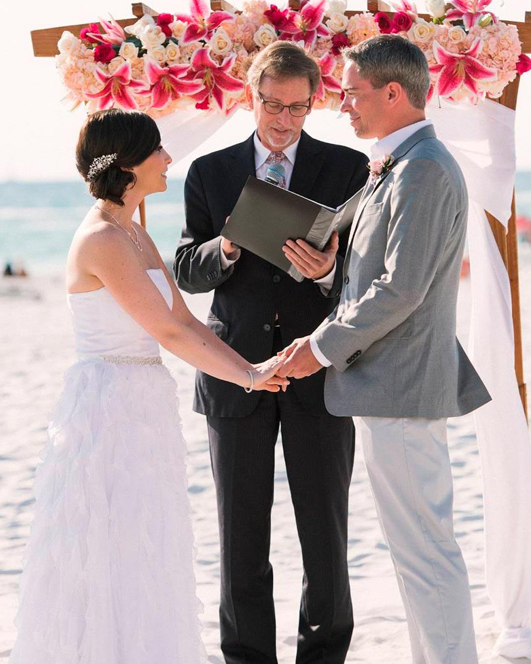 wedding officiant speeches arch ceremony bride groom beach