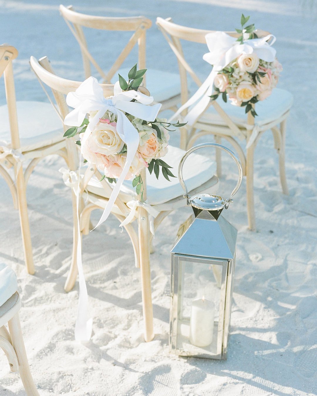 beach wedding decoration ideas flowers and ribbons decorate chair natalie watson photography