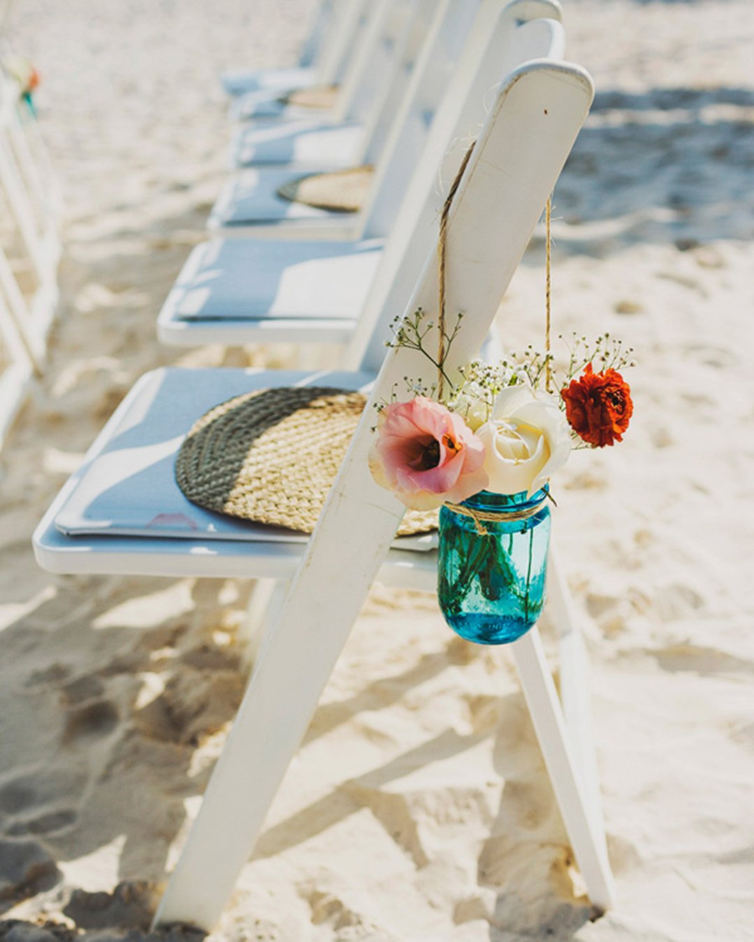 beach wedding decoration ideas with floral on the chair ariel renae photography