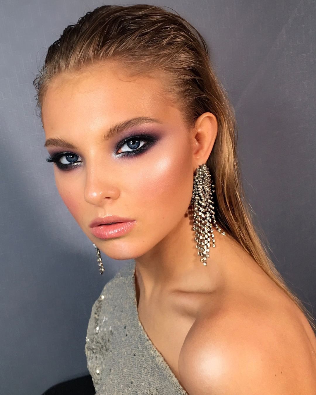 Makeup look with bold red lip and a heavy black smokey eye to complete the look