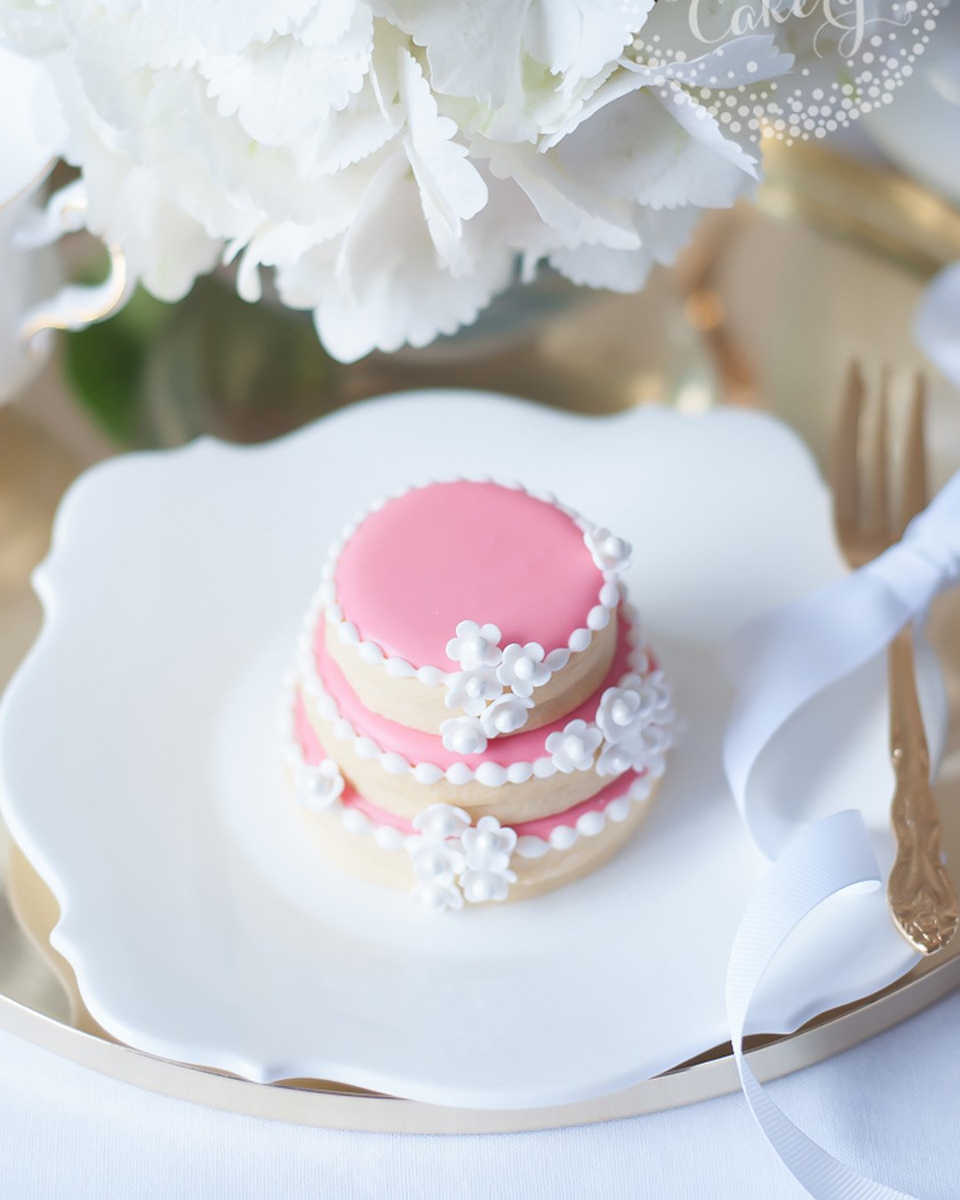 wedding cake cookies pink with white decor junipercakery