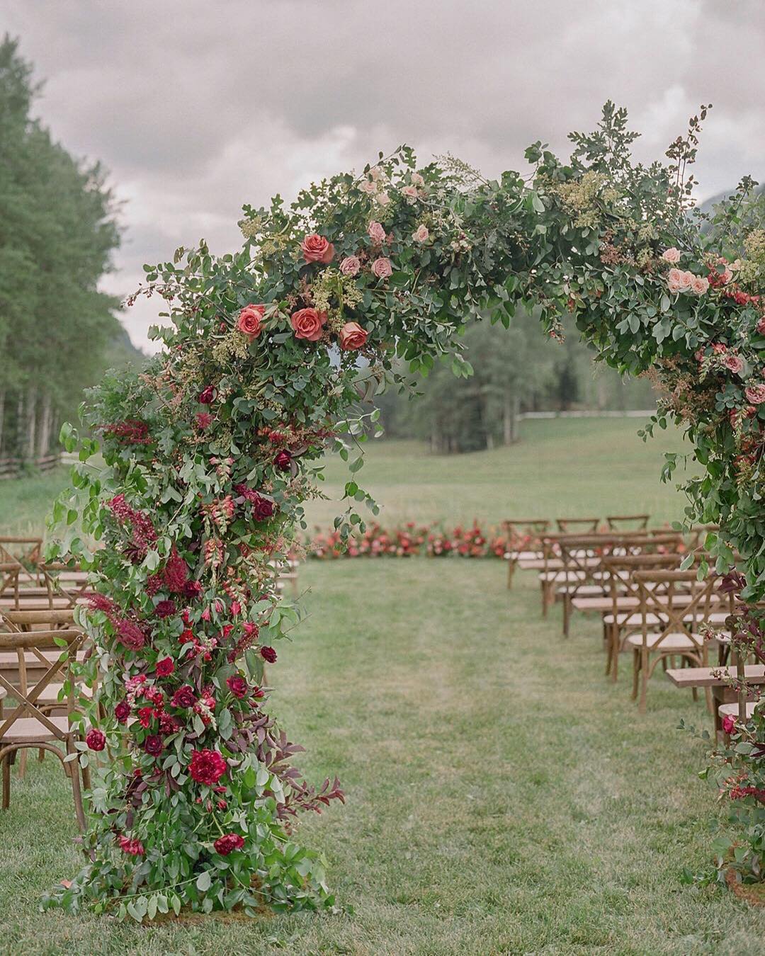 wedding ceremony decorations outdoor with greenery arch lauramurray