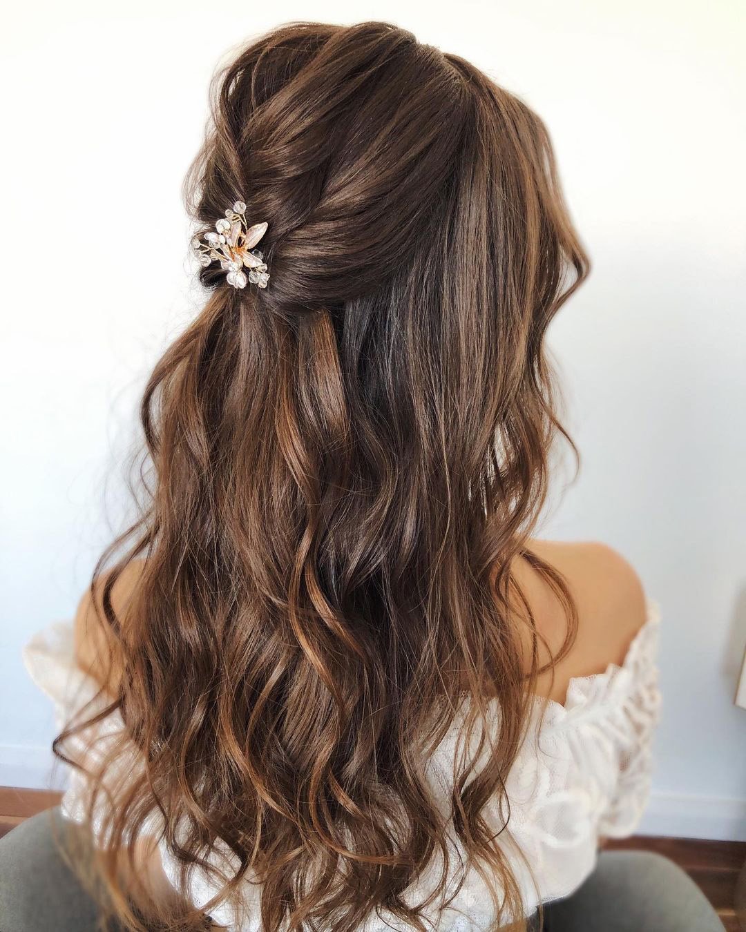 wedding hair trends half up half down with swept and flower pin caraclyne.bridal