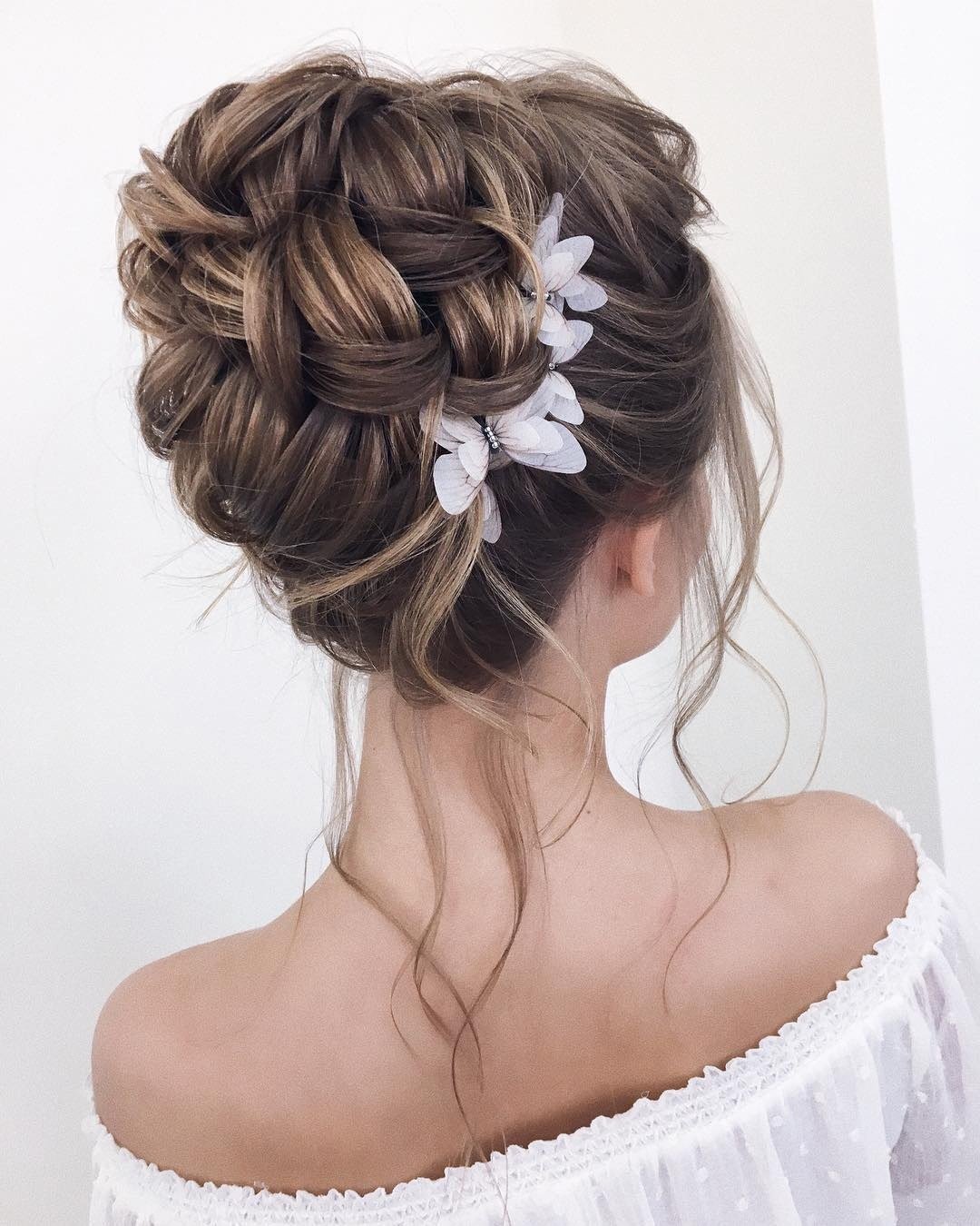 wedding updos for long hair textured high volume bun with loose curls xenia_stylist