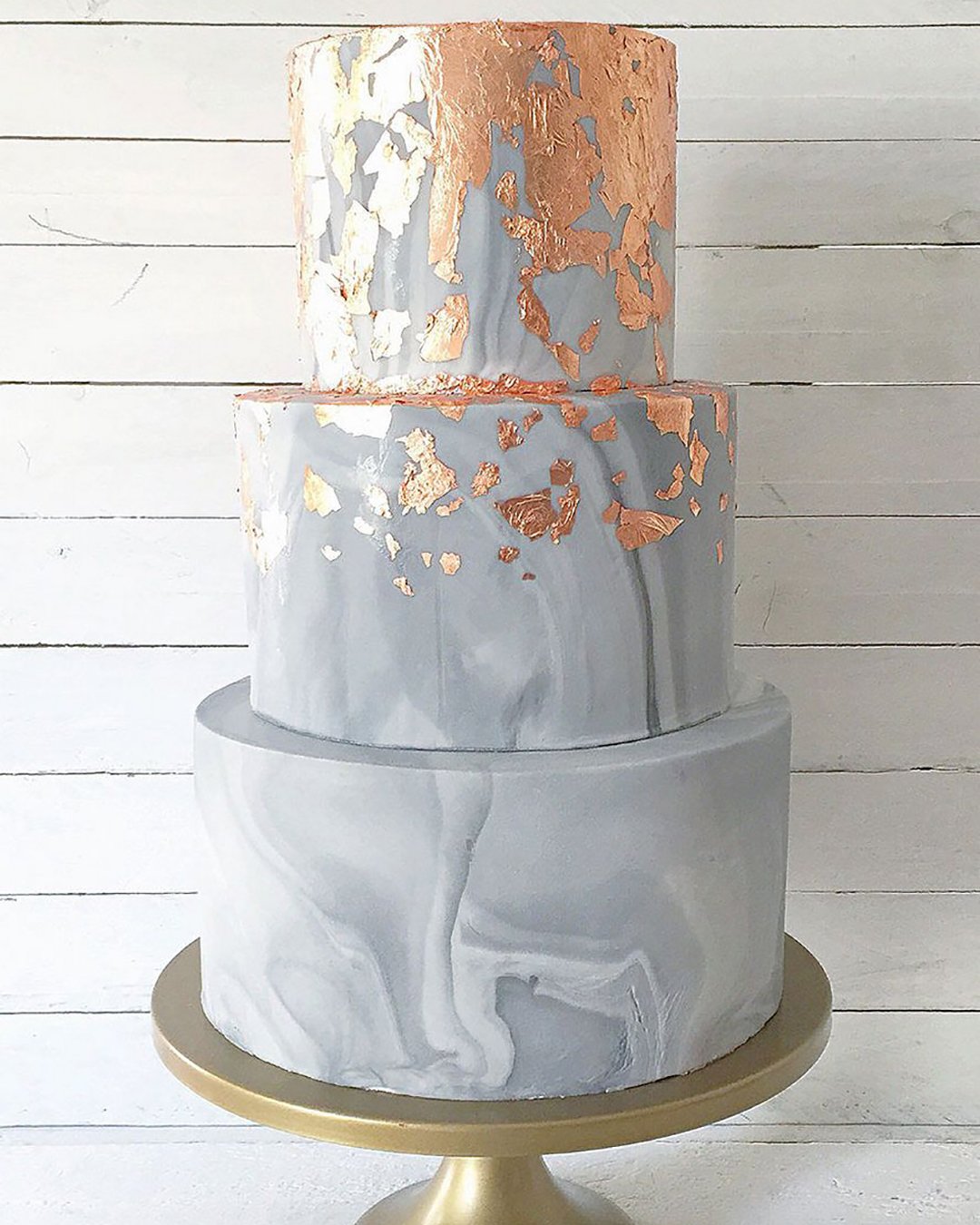 marble wedding cakes three tiered dark cake with golden divorces on a golden plate wedspire via instagram