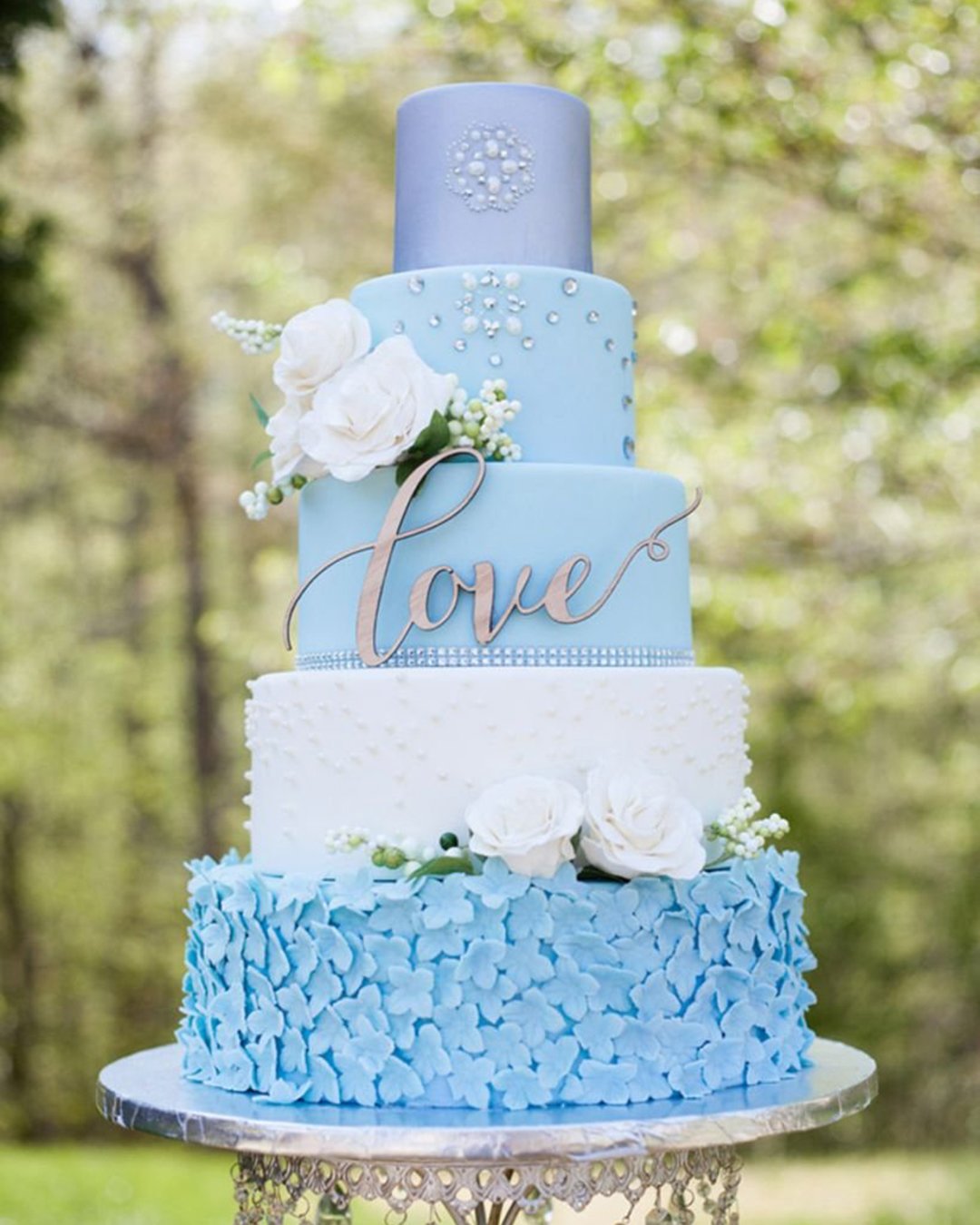 beautiful wedding cakes tall blue cake decorated with white roses and the inscription love rebekah naomi cake desi