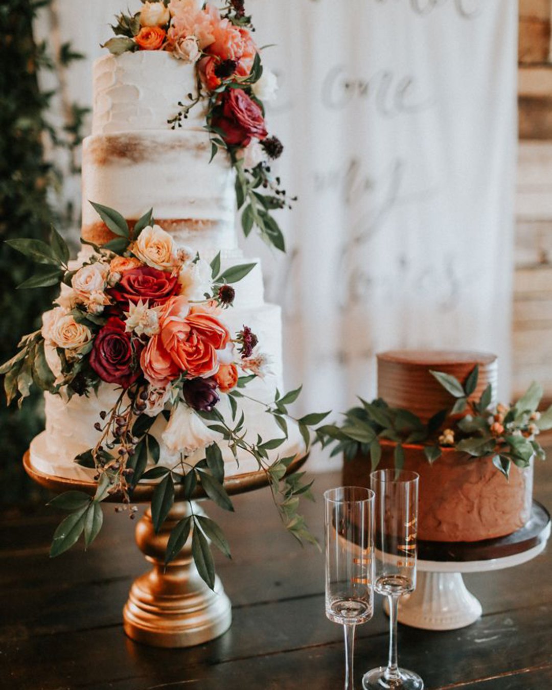 beautiful wedding cakes tall white cake with fresh roses chocolate cake with greens nearby melissa marshal