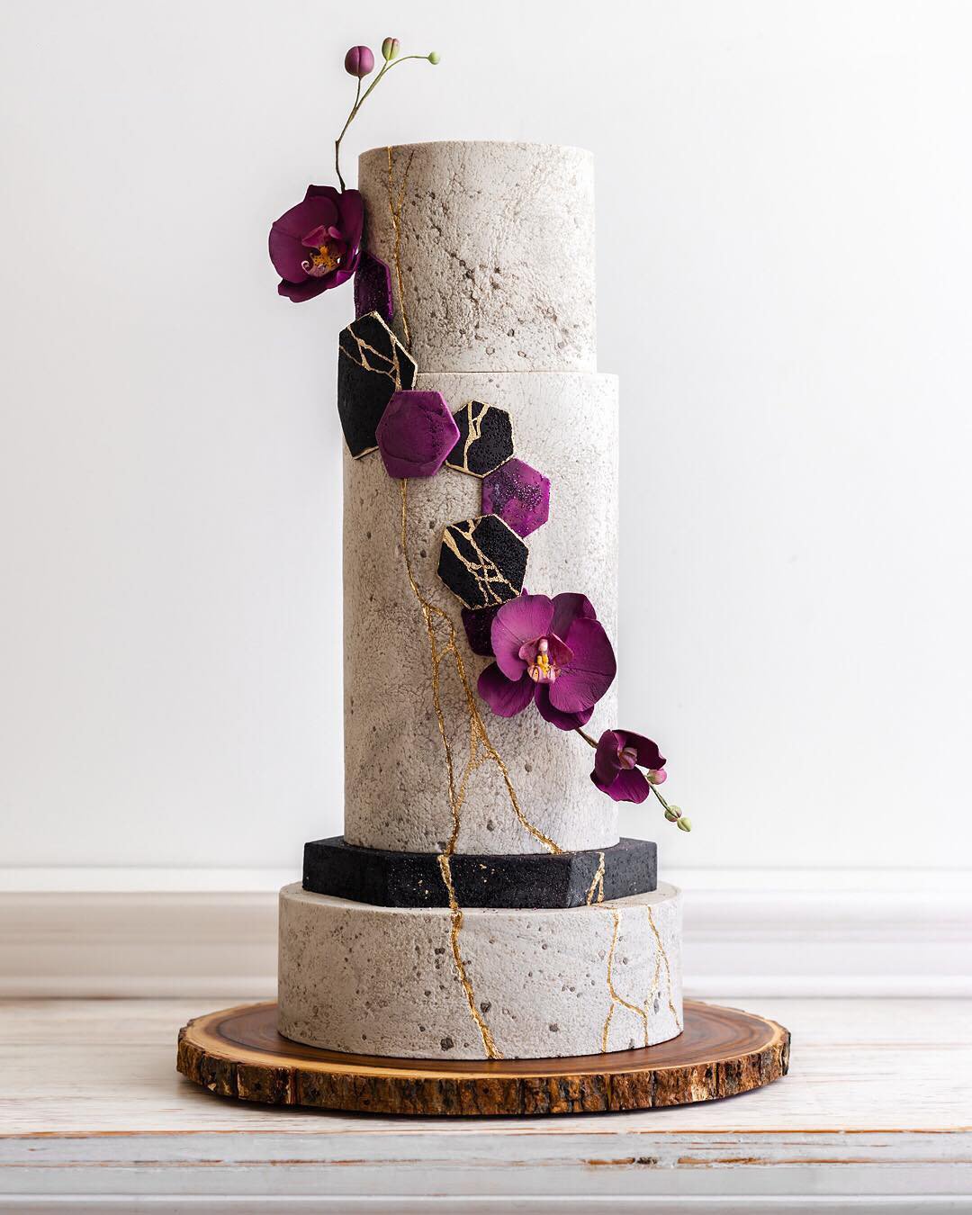 black and white wedding cakes tall stone with orchids and gold delacremestudio