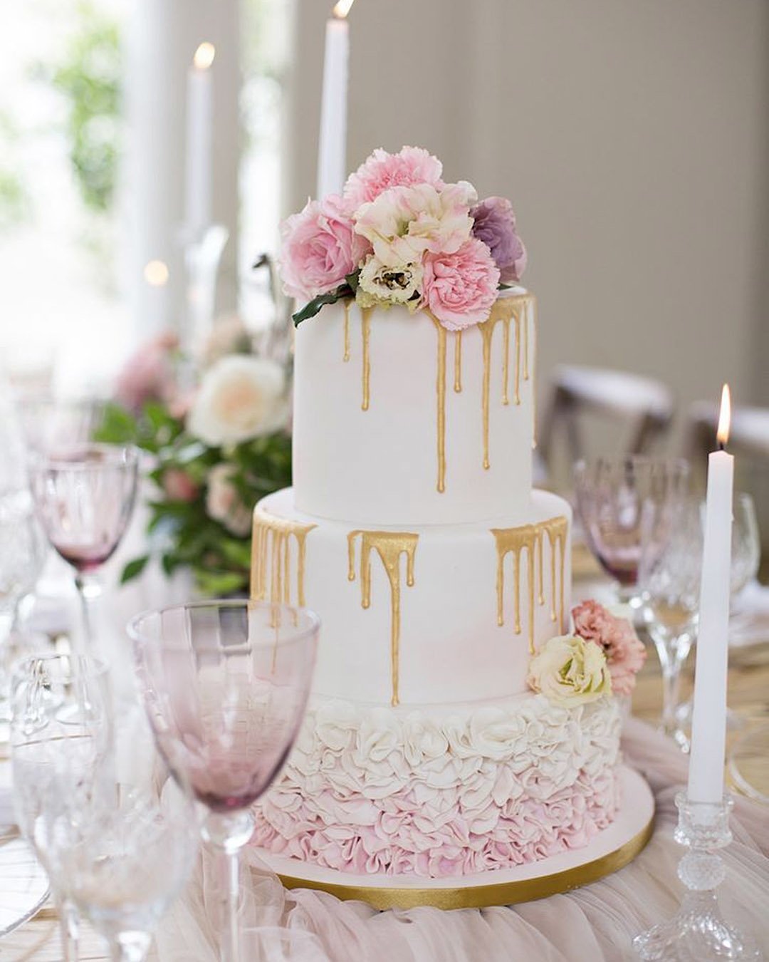 drip wedding cakes white lilac pink with flowers and candles gold