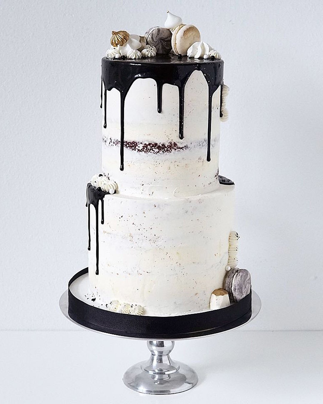 drip wedding cakes white naked with black macarons